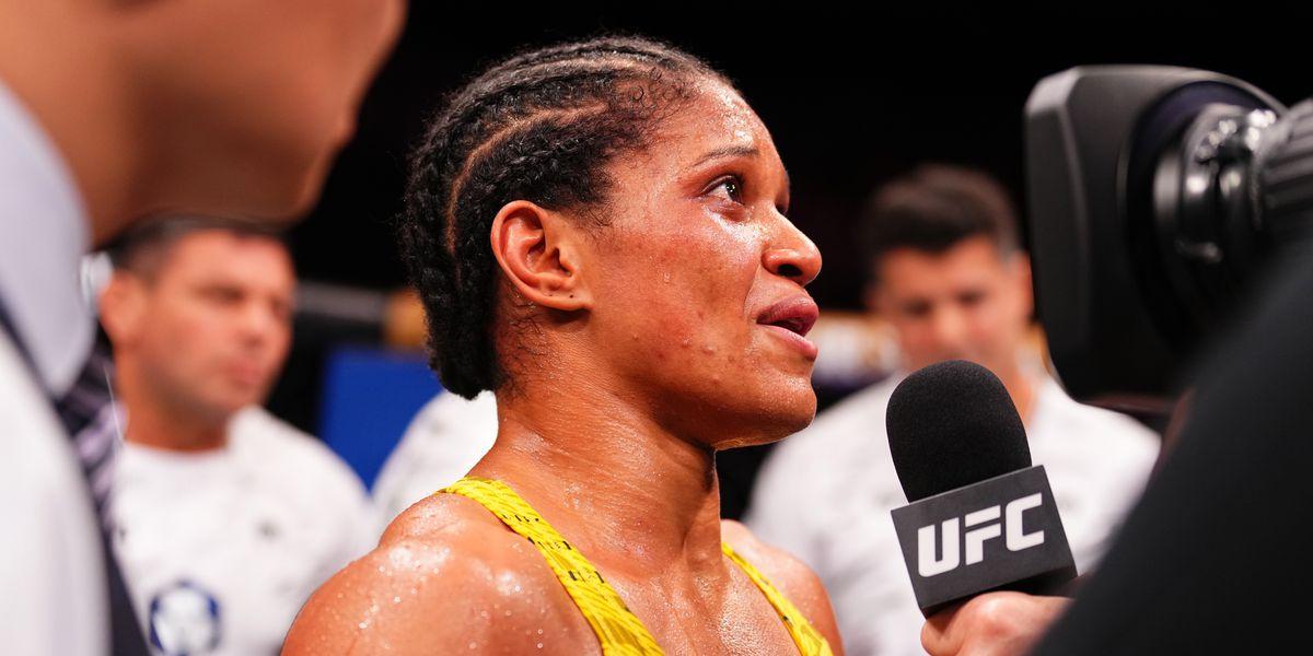 Gabriella Fernandes pulls off a stunning upset against Wang Cong at UFC Macau, dedicating her win to her late sister and showcasing her determination and fighting spirit.