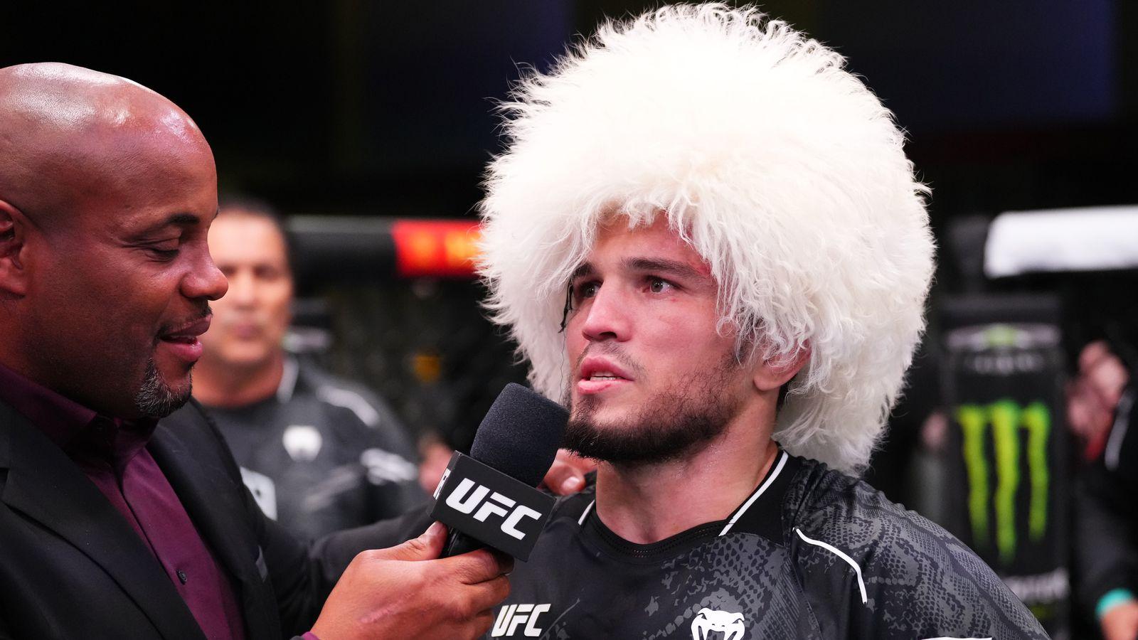 Umar Nurmagomedov faces Merab Dvalishvili at UFC 311 despite a broken arm, testing his physical and mental strength in a crucial bantamweight championship match.